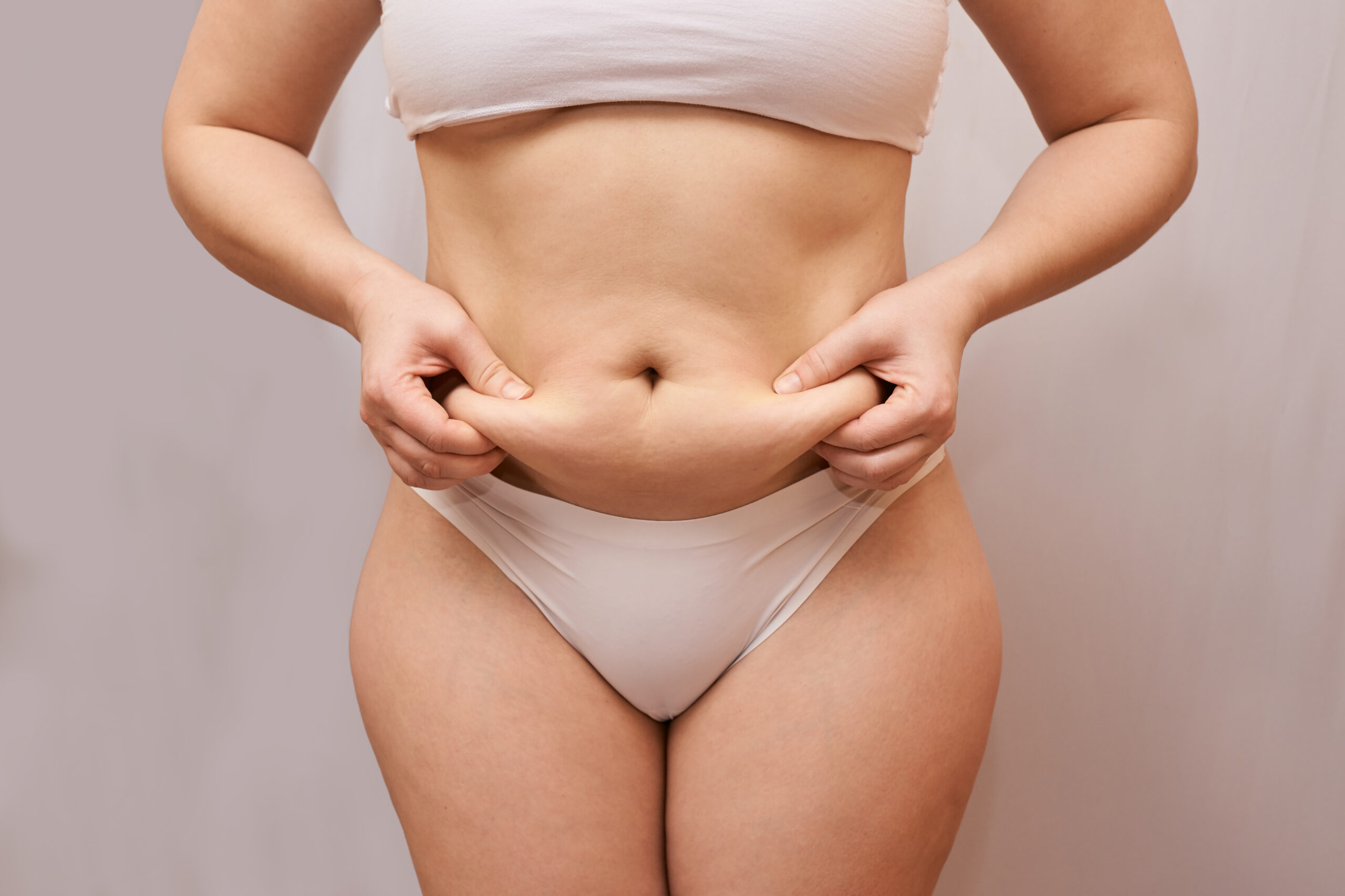 Fat unhealthy woman body. Pinch belly side. Measurement lady procedure. Medicine